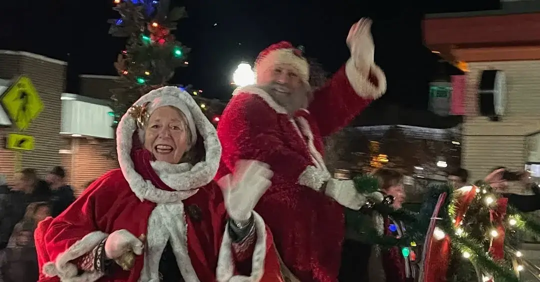 Santa riding his sleigh in the holiday parade.