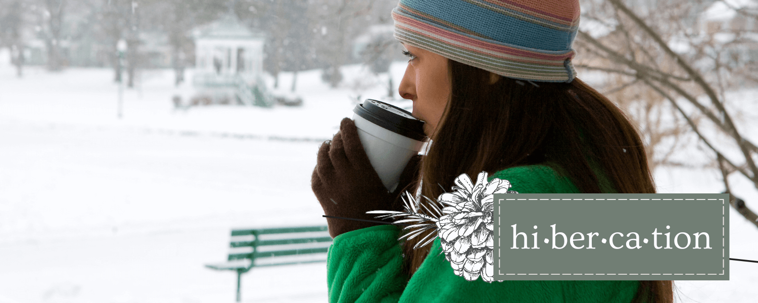 women in winter clothing drinking a hot beverage