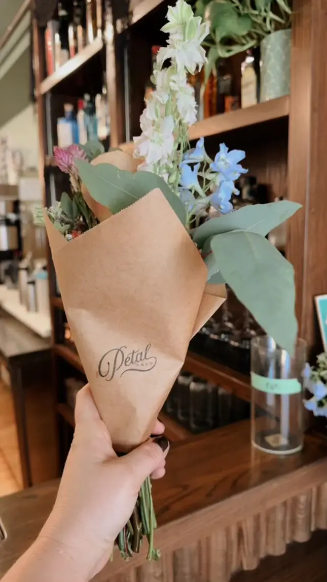 woman's hand holding a few flowers