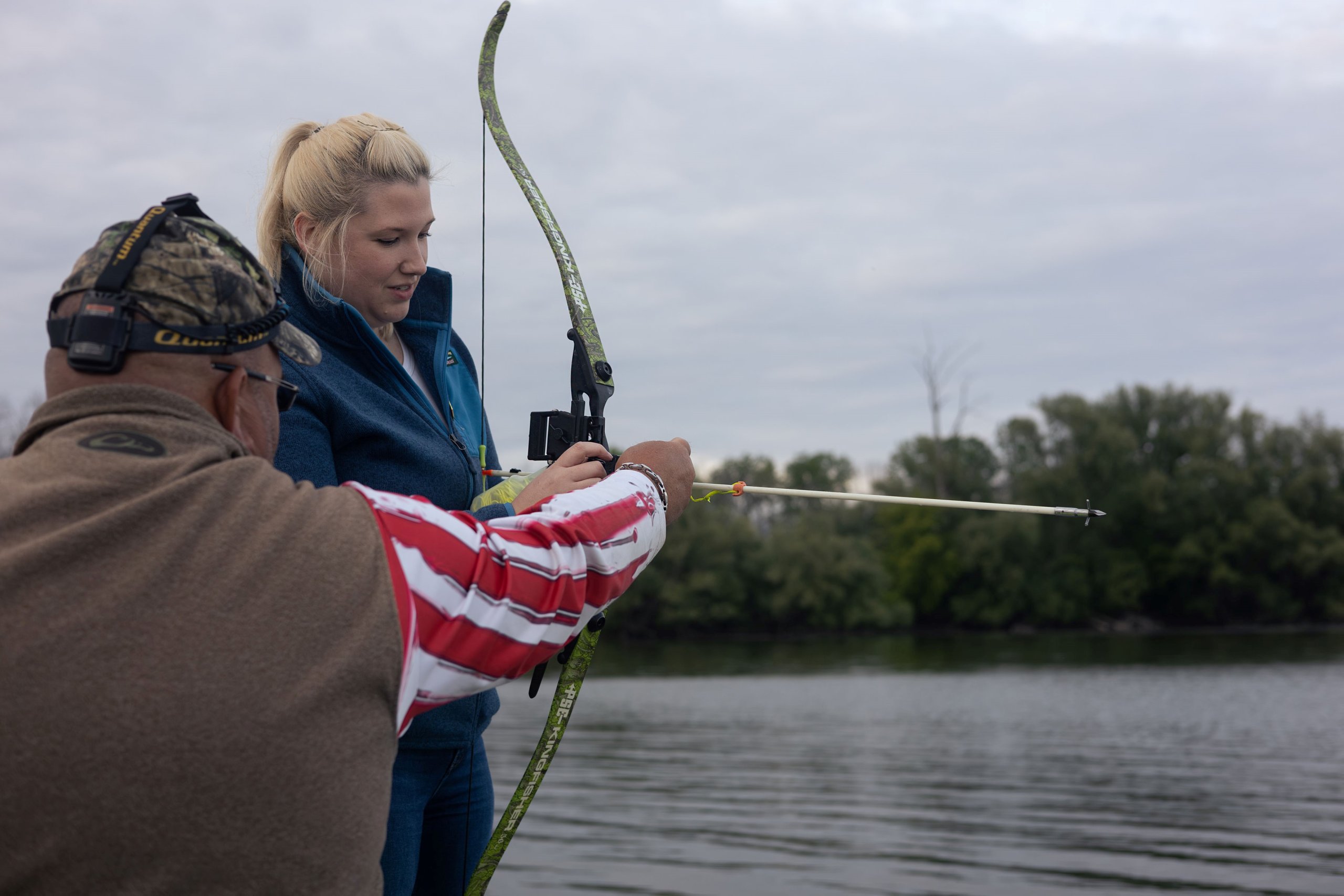 Man and a women on a boat bow fishing