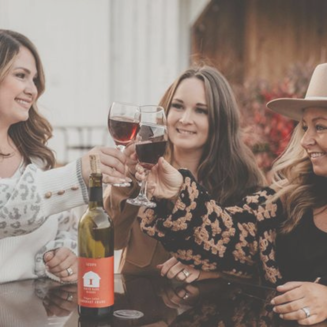 three women enjoying a glass of wine