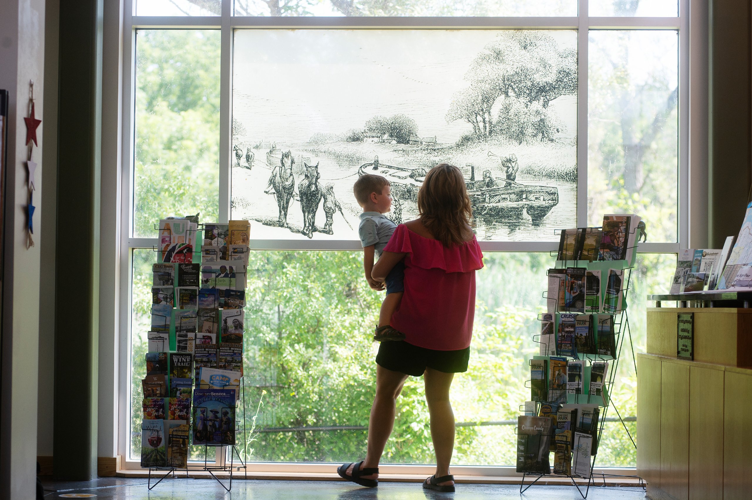 women with small child looking at an exhibit at the Port Byron Erie Canal Museum