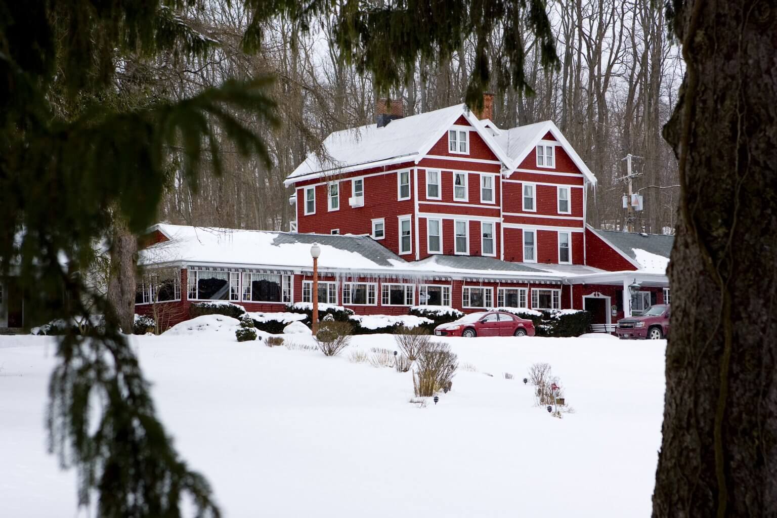 Exterior of an Inn in the winter with the ground covered in snow